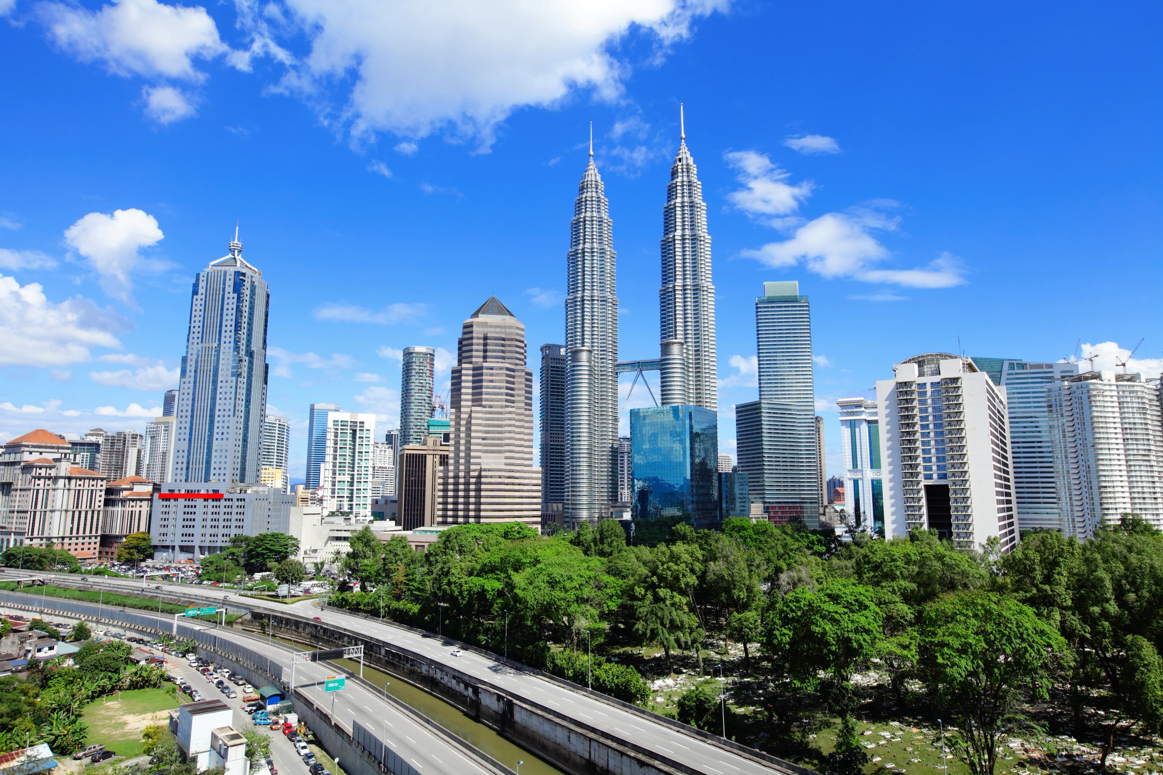 Malaysia reflected in water under a clear sky